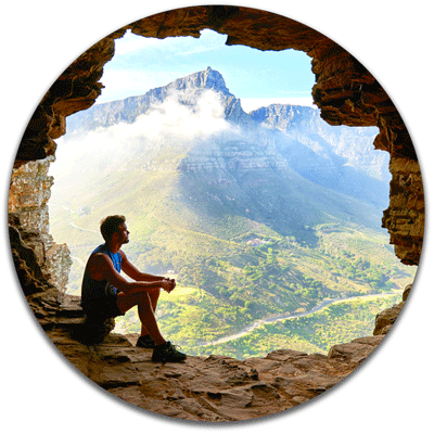 Circular large wood print of man sitting on cliff edge
